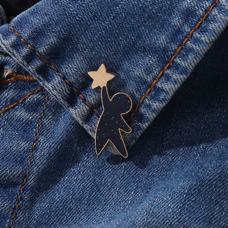 Celestial black enamel pins with star designs