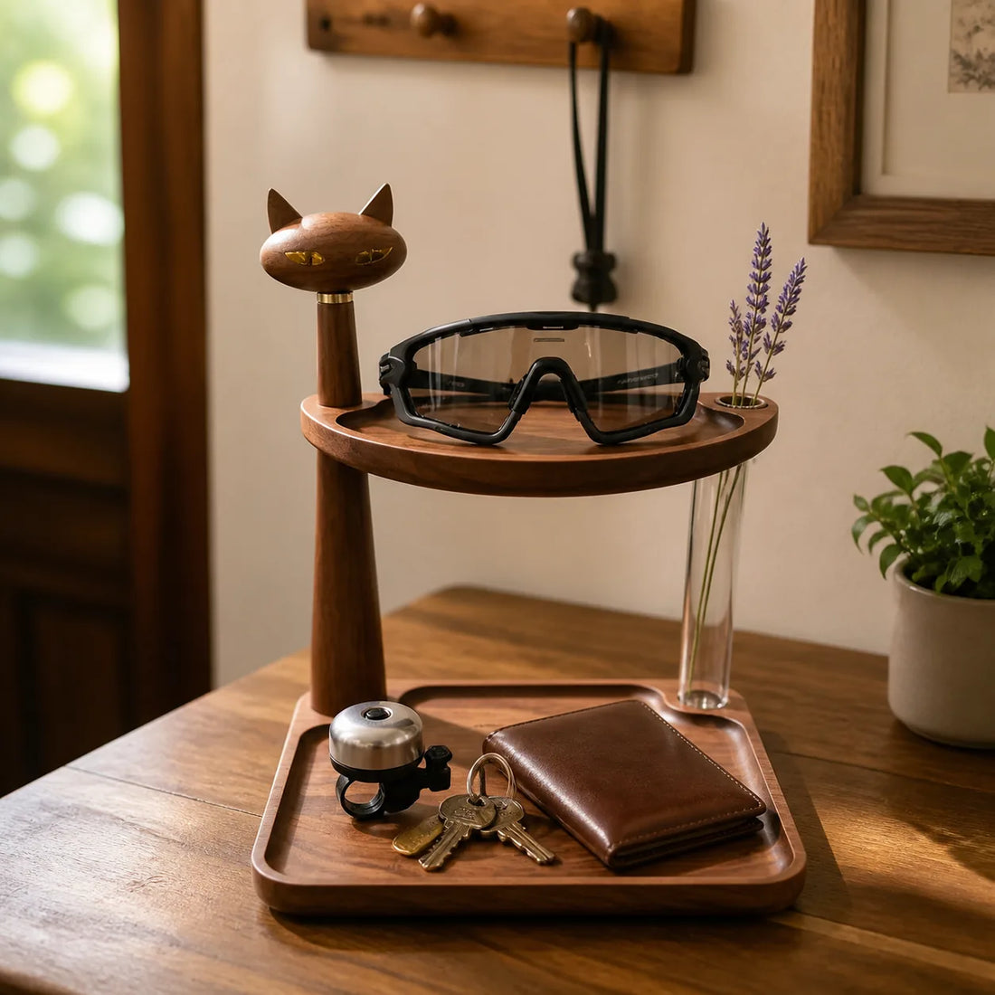 Wooden cat valet tray holding cycling glasses, keys, wallet, and bike bell